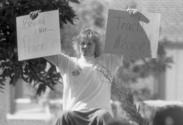  a woman protests the Gulf War during Military Awareness Day