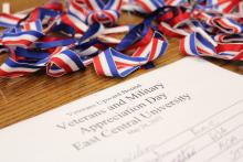 photo from the 2012 Veterans, Military Appreciation Day, hosted by East Central University’s Veterans Upward Bound Program. In the photo is the registration sheet along with red, white and blue ribbons.