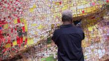 Ghanaian sculpture El Anatsui works on one of his pieces.