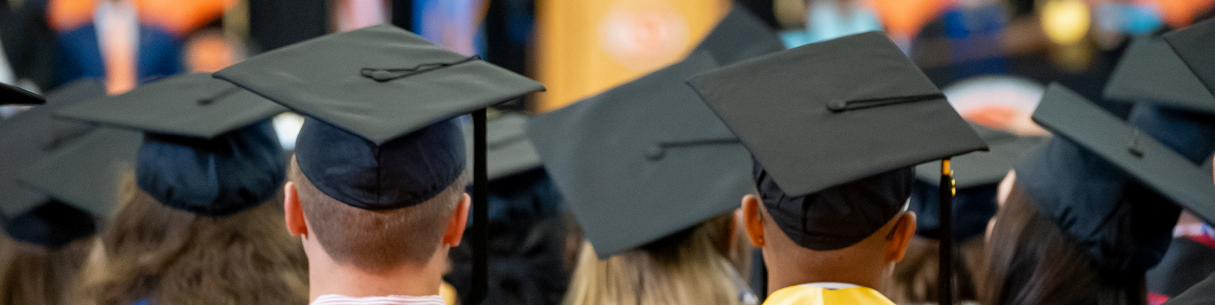 back of students' heads in caps