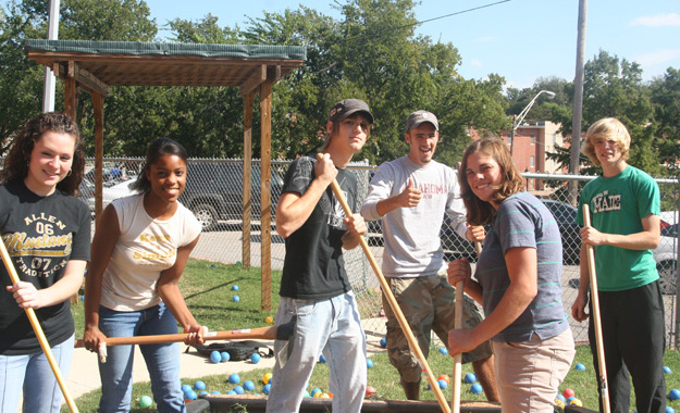 Students clean up for a service learning project.