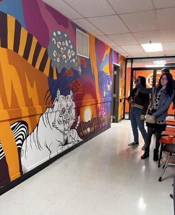 Art students pose in front of a mural they completed over the course of two semesters at East Central University.