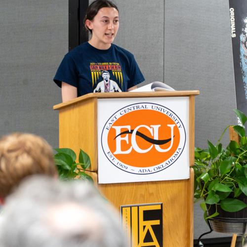 A student reads their entry from Originals 2025.