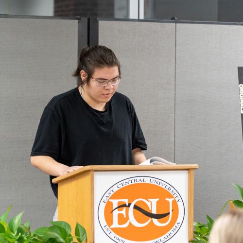 A student reads their entry from Originals 2025.