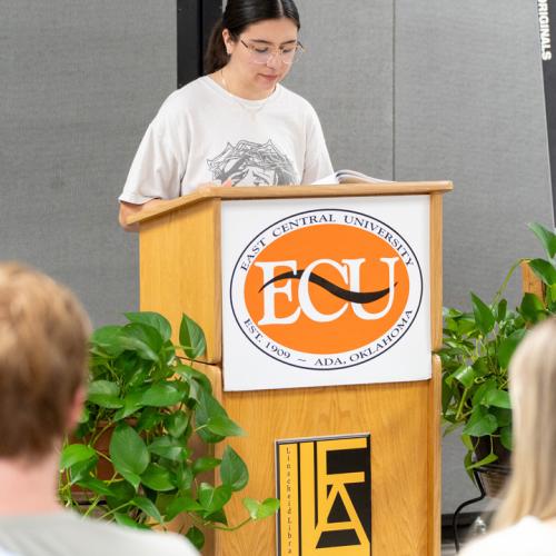 A student reads their entry from Originals 2025.