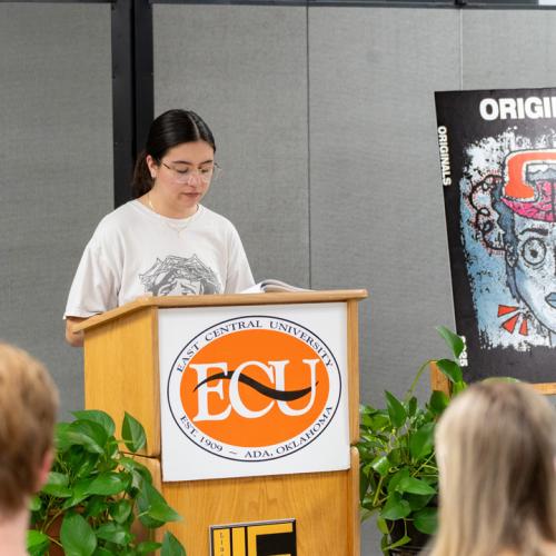 A student reads their entry from Originals 2025.