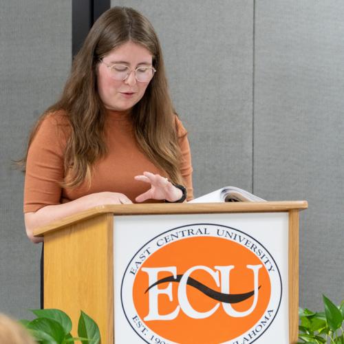 A student reads their entry from Originals 2025.