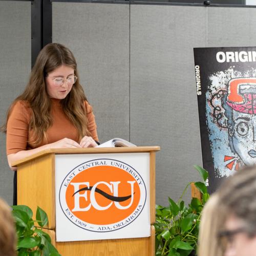 A student reads their entry from Originals 2025.