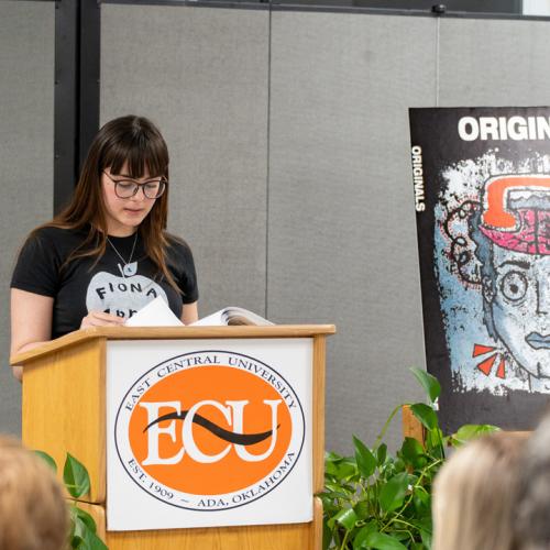 A student reads their entry from Originals 2025.