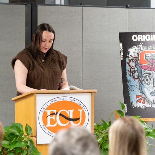 A student reads their entry from Originals 2025.