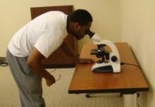 obert Frazier, a student at Ada High School, peers through the telescope