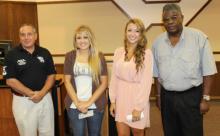 Sisters Charlsey Foster (center, left) and Breanna Foster (center, right) pose after receiving scholarship awards from the Oklahoma Veterans Council and the Mid-America Chapter of the Paralyzed Veterans of America. At far left is Scott Ellis, government relations director for the Mid-America Chapter of the Paralyzed Veterans of America, and at the far right is Pete Peterson, chairman of the Oklahoma Veterans Council.