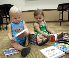 Bennett and Bliss Henson look over some of the books Smart Start South Central donated for the waiting area