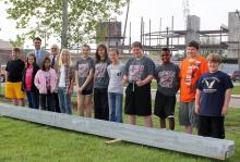 Willard students posing by beam