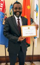 Dr. Erick Ananga earns Teacher of the Year award.