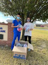 Jessica Shores, a Licensed Clinical Social Worker (in scrubs) and Raven James, an ECU Social Work student, prepare to deliver blankets to local dialysis patients.