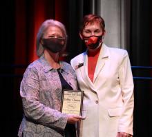 ECU Academic Advisor and NCAA Eligibility Officer Debbie Claxton, left, accepts the prestigious Charlee Lanis Memorial Staff Award from Dr. Katricia Pierson, ECU president. The Lanis Award is the highlight of the annual ECU Employee Appreciation event and goes to a dedicated, longtime employee who goes above and beyond in service to others