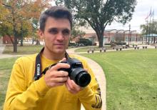 Cliff Tomlinson, a junior from Coalgate, snaps a photo on the ECU campus. Tomlinson is a recipient of the prestigious OETA broadcasting scholarship.