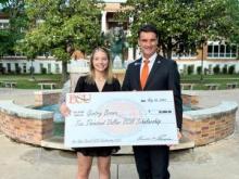 Gentry Brown, left, received a $10,000 scholarship from East Central University President Wendell Godwin. 
