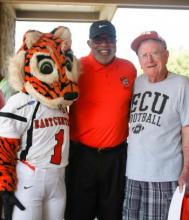 Roary poses for the camera with the Honorable Dewey McClain and Coach Pat O'Neal at the annual Alumni Golf Tournament in 2021.
