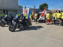 Participants prepare to walk down Ada's Main Street in the "Step out of the Darkness" event to bring awareness to addiction. 