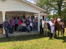 Lancaster family photo outside with two horses included