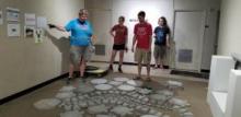 Photo of Shape of the River team with the project work in progress (concrete pavers on the floor). The Shape of the River project was funded by a research grant from the Oka’ Institute. Working on the project with Yoncha is Dr. Christine Pappas and undergraduate research assistants Lauren George, TJ Norman, Delanie Seals, Serena Neal.